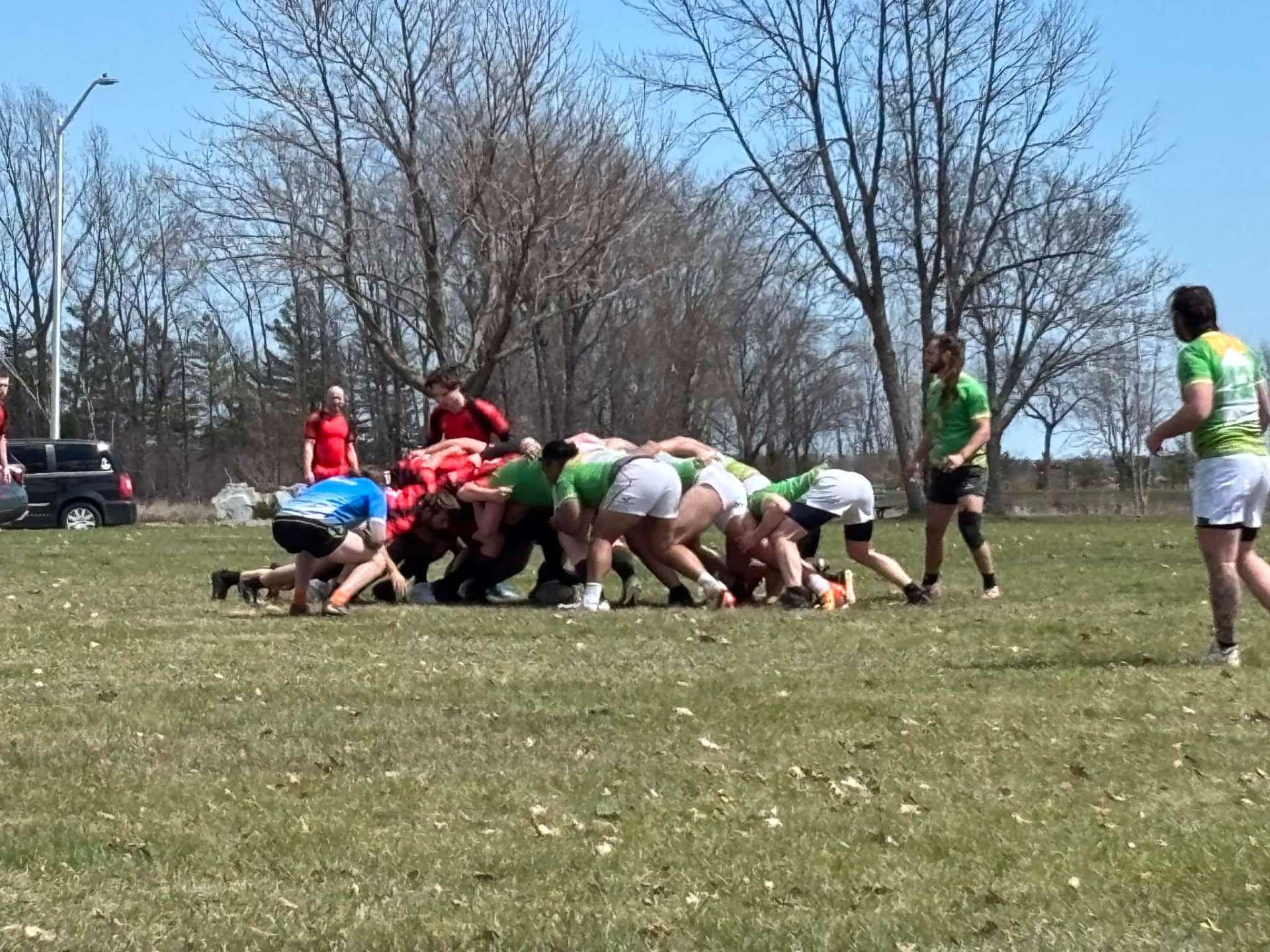 Berserkers scrum against a rival club — red kits engaged in the pack